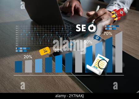 Using a laptop to create SEO (search engine optimization) material Technology for Business Marketing and SEO Stock Photo