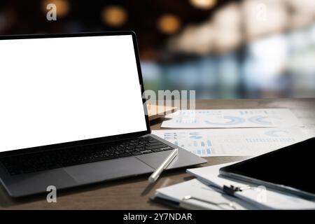 man working on laptop computer at home Laptop with blank screen on table for your advertising text message Stock Photo