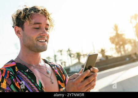 stylish millennial guy using mobile phone Stock Photo