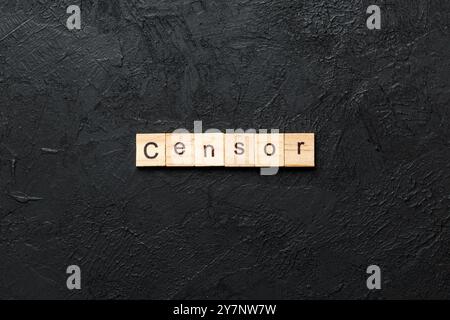 Censor word written on wood block. Censor text on cement table for your desing, concept. Stock Photo
