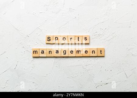 sports management word written on wood block. sports management text on cement table for your desing, concept. Stock Photo