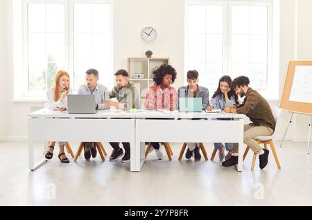 Business Team or Students Collaborating in Office with Laptops Stock Photo