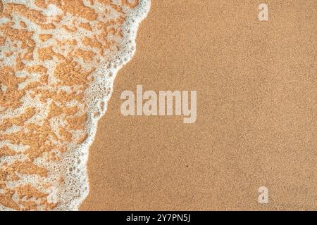 Texture of sea foam and wet sand at the beach in summer, top down Stock Photo