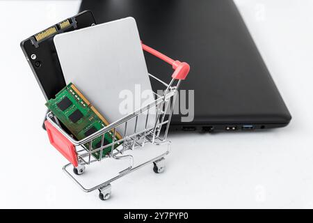 Closed-up view of computer parts in a shopping cart. Computer laptop upgrade concept Stock Photo