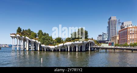 A bright sky over NYC tourist mecca Little Island, the park built atop concrete “tulip pot” pilings in the Hudson River at West 14th Street. Stock Photo