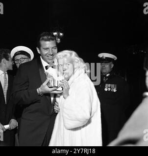 JAYNE AND HUSBAND AT FILM PREMIERELondon, England, UK : Hammer Films' new British Film for Columbia Pictures 'Yesterday's Enemy', was premiered tonight at the Empire Theatre, Leicester Square. The function, held under the auspices of the Burma Star Association, included many Army men who took part in the Burma campaign and several hundred holders of the Burma Star, in addition to a host of well known movie stars. Here, actress Jayne Mansfield takes a little light refreshment at the premiere with her husband, Mickey Haritay. 17 September 1959 Stock Photo