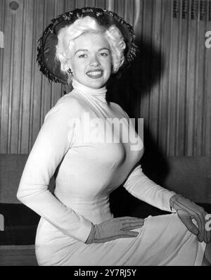 JAYNE MANSFIELD ARRIVESWearing a mauve woollen skin tight dress Jayne Mansfield arrived this afternoon at London Airport, accompanied by her husband Mickey Hargitay. Miss Mansfield, the famous American film actress is going to make a film in this country with Kenneth More, the title of the film is The Sheriff of Fractured Jaw. Photo shows: Jayne Mansfield pictured at London Airport on her arrival this afternoon. 26 April 1958 Stock Photo