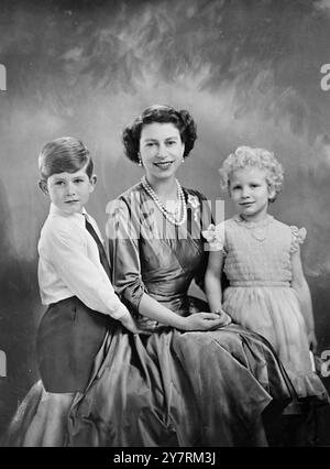 TO RELEASE ON 26 JANUARY, 1954. Royal Command Portrait by Baron H.M. QUEEN ELIZABETH II The Queen is seen in a yellow tulle evening gown decorated with sprays of mimosa and gold paillette embroidery. She is wearing the blue Ribbon and Star of the Garter. These are some details of Her Majesty's diamonds shown in the portrait: the tiara, a wedding present from Queen Mary; the necklace, a wedding present from the Nizam of Hyderabad; the bow brooch, drop earrings, bracelet, and platinum wristwatch are also set in diamonds. The portrait study was taken on the small staircase in the Grand Entrance a Stock Photo