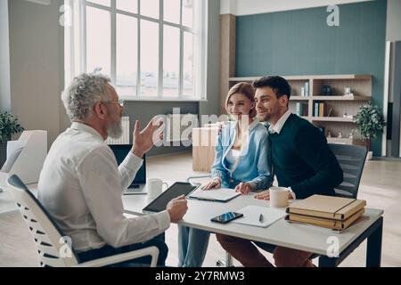 Financial advisor making presentation to his clients while having meeting in the office Stock Photo