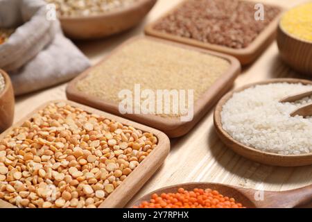 Different types of cereals and legumes on table, closeup Stock Photo