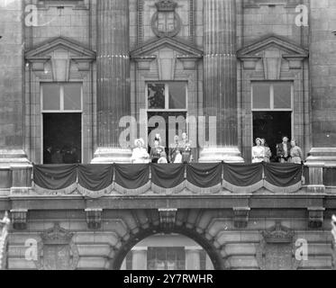 QUEEN AT TROOPING 11.6.53.  H.M. the Queen, who is Colonel-in-Chief of the seven Regiments of the Household Brigade, took the salute at the Trooping the Colour ceremony on Horse Guards Parade today, her official birthday. She wore the uniform of the Grenadier Guards, the colour of whose first battalion was trooped.   Photo shows Princess Anne calls to someone inside the Palace as the Royal Family watch the R.A.F. fly-past from the balcony. Prince Charles stands open-mouthed in front of the Duke of Gloucester and the Duke of Edinburgh (extreme right), while Queen Elizabeth the Queen Mother is a Stock Photo