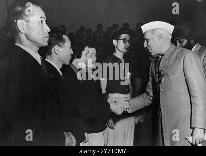 INDIAN PREMIER CONGRATULATES JAPANESE WINNERS OF TABLE TENNIS After the conclusion of the World Table Tennis matches in Bombay, the Indian Capital, New Delhi, received the Japanese and Pakistani teams and witnessed exhibition matches played at the YMCA on February 14th. Among the spectators was the Prime Minister of India Pandit Nehru, who watched the game with keen interest.  PHOTO SHOWS:- Pandit Nehru, Indian Premier shaking hands with Miss Shizuka Narahara, victorious as he congratulates the Japanese team, in New Delhi. 18 February 1952 Stock Photo