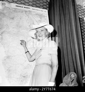 Britian's famed intrepid lone woman flyer, Miss Sheila Scott, explains the route she hopes to take on her bid to set up new records from London to Nairobi, and from Nairobi to Cape Town, at a press conference in London today. When Sheila takes off from London Airport on September 4th in her world famous Piper Comanche light plane, she will be flying what could be called a 'flying petrol bomb'. The tiny plane will be carrying 250 gallons of petrol, nearly three times the normal maximum. Most of the petrol will be carried in two huge ferry tanks crammed into the cabin behind her.  28 August 1969 Stock Photo