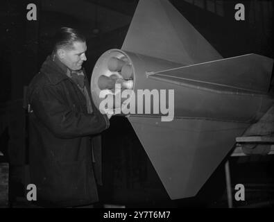 CLOSE-UP OF BRITISH ROCKET    Close view of the jet outlet and tail fins of British Experimental Rocket as the missile was taken into the New Horticultural Hall, Westminster, London, today for its first public showing. The rocket, 20 feet long and 17 inches in diameter, it is to be on view at the Ministry of Supply stand at the Schoolboy's Own Exhibition, opening on January 1. A similar missile has been launched from a site ' somewhere in Britain ', the details of its performances have not been divulged .   28 December 1950 Stock Photo