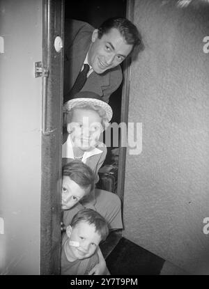 GREGORY PECK'S DEPARTURE   25 May 1950    Faces around the cabin door belong to American film actor Gregory Peck, Mrs Peck and their two sons Jonathan 5, Stephen 3 (bottom).  The Pecks are seen on board the Cunard White Start liner 'Queen Elizabeth' at Southampton as they started their journey home.  Gregory Peck came to Britain to play the lead in the new film 'Captain Horatio Hornblower'. Stock Photo