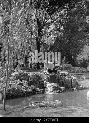 CHELSEA HAVEN   22 May 1950    Haven of peace and loveliness in the hubbub of London is this rock garden (nymph above the water fall is June Naef of Surbiton, Surrey) - constructed in the grounds of the Royal Hospital for the Chelsea Flower Show.  The show - highlight of the horticultural year - opens for private view tomorrow (Tuesday) and to thep ublic on Wednesday Stock Photo