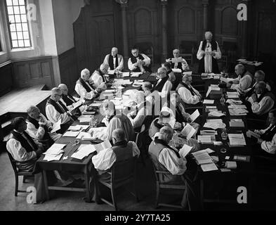 BISHOPS AT CONVOCATION - - - - 23 May 1950 - - - - The scene at the Convocation of Canterbury in Church House, Westminster, London today (Tuesday) - - Speaking is the Bishop of Winchester, Dr Mervyn George Haigh (standing). Also at the top table are - from left - the Bishop of Birmingham Dr E W Barnes, the Bishop of London, Dr JWC Wand, and the Archbishop of Canterbury, Dr Geoffrey Fisher, who is presiding. Stock Photo