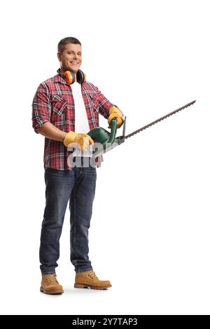 Full length portrait of a young man with a chainsaw isolated on blue background Stock Photo