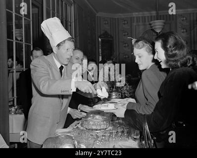 DANNY KAYE DELIVERS THE GAGS 5 April 1950  Delighting his guests as he does millions from stage and screen, versatile American entertainer Danny Kaye dons a chefs hat and turns his hand to a little serving at a reception in the Savoy Hotel, London today, (Wednesday).  He is here with his wife for a holiday and later will make a musical comedy film in the South of France. Stock Photo