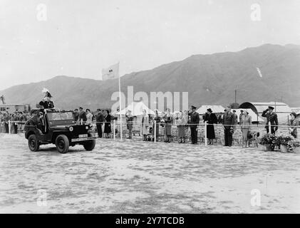 GOVERNOR IN A JEEP AS BRITAIN SHOWS STRENGTH IN HONG KONG - - - - Riding in a Jeep, Sir Alexander Grantham, K.C.M.G., Governor of Hong Kong, inspects one of the biggest British parades ever held in the far east. About 5,000 officers and men of the 40th infantry division, under the general officer commanding, Major-General G.C. Evans, had assembled on the airstrip at Sek Kong in the New Territories of Hong Kong colony. - - 24 march 1950 Stock Photo