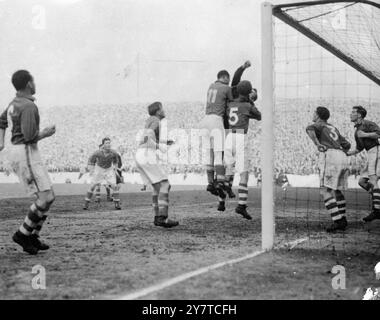 FIRST GOAL FOR LIVERPOOL25 March 1950  A determined effort by Everton players fails to stop the ball going into their net for Liverpool's first goal in the FA Cup Semifinal match at Main Road ground, Manchester, today (Saturday). Bob Paisley kicked the goal. Jumping in the goal mouth are George Burnett, Everton's goalkeeper (first visible), and Dave Falder the centre half (No.5). Liverpool won the battle two to nil.  They will meet Arsenal in the Football association Cup Final at Wembley, London on April 29. Stock Photo