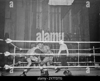 SHOULDER TO SHOULDER There's a fierce and fiery intensity about this middleweight clash between RANDOLPH TURPIN  ( left) and RICHARD ARMAH at the Davis Theatre , Croydon , Surrey . Turpin , one of the three Leamington boxing brothers all fighting on the same bill this evening , was given the verdict when the hard-hitting British West African retired at the end of the sixth round of their scheduled eight-round match . 6 March 1950 Stock Photo