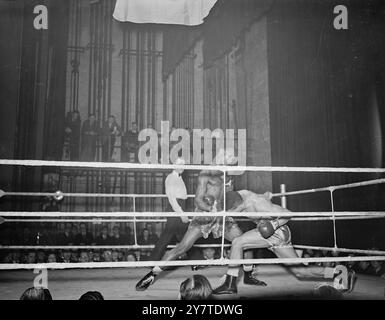 DUCKING INTO TROUBLE   Randolph Turpin, one of the three Leamington boxing brothers and contender for the European middleweight title, ducks into a right from the hard-punching British West African Richard Armah in their bout at the Davis theatre Croydon , Surrey , tonight. 6  March 1950 Stock Photo