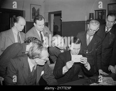 SIR STAFFORD STUDIES A FLOATING VOTE  Is it a spoilt ballot paper? Presiding officer isn't sure. Sir Stafford Cripps (left), chancellor of the Exchequer, peers at it, but can't make up his mind either. Extreme right, Mr. R.E. Simms, the Conservative candidate, awaits the verdict. This moment of decision occurred as the votes cast in south-east Bristol were counted early this morning. When the count was so far, Sir Stafford had won the seat for Labour with 29,393 votes, a majority of 16, 803 over Mr.Simms (12, 590). Mr.F. Goude , the liberal polled 4, 463 : Mr.J.F. Webb (communists), had 524 vo Stock Photo