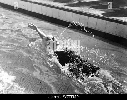 THERE SHE BLOWS 11 February 1950  Fountain of energy in the Olympic Pool at Auckland, New Zealand, Springs from Empire Games competitor Pat Seymour (Australia). Miss Seymour represented her country in the women's 100 yards backstroke swimming event. Stock Photo