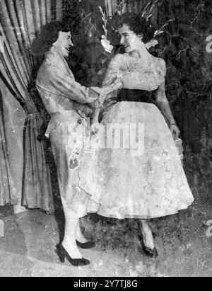 New York : Film actress Elizabeth Taylor , who marries Conrad Hilton Jnr , aged 23 , on 6 May , tries on some of the dresses which form part of her trousseau.20 March 1950 Stock Photo