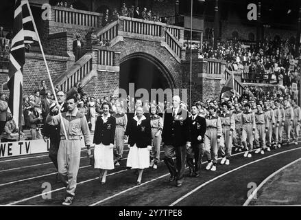 The British team, preceded by the Union Jack carried by hurdler Tom Farrell, marches on to the track at the Olympic Stadium in Stockholm, Sweden, this afternoon for the opening of the European Athletics Championships.19 August 1958 Stock Photo