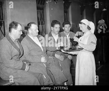 FRENCH SOLDIERS IN ENGLISH HOSPITALWounded French soldiers , convalescing in an English hospital , still receive their ration of wine just as if they were in France . Parcels of comforts sent by the public include two cases of champagne. Photo shows: A nurse pouring out the 'vin rouge' for French soldiers at the hospital . 23 June 1940 Stock Photo