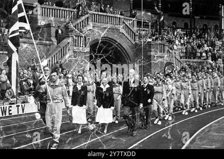 The British team, preceded by the Union Jack carried by hurdler Tom Farrell, marches on to the track at the Olympic Stadium in Stockholm, Sweden, this afternoon for the opening of the European Athletics Championships.19 August 1958 Stock Photo