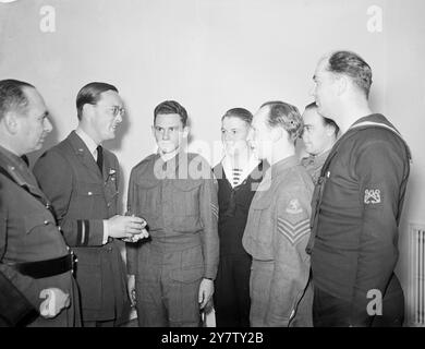 PRINCE BERNHARD ATTENDS NATIONAL SAVINGS PUBLIC INTEREST LUNCHEON. Prince Bernhard of the Netherlands was guest of honour at a luncheon given by the National Savings Public Interest Committee, at the Dorchester HOtel, London.  Photo Shows: Prince Bernhard (left) chatting to Free Dutch soldiers and sailors, at the luncheon.  28 May 1941 Stock Photo