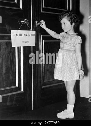 THE QUEEN INSPECTS CHILDREN'S DRESSES Whilst at Buckingham Palace, Her Majesty the Queen inspected copies of childrens cotton frocks which are being exhibited in New York, and which have been sent by Britain to the United States, to bring in more money for the war effort. An exhibition on the same lines is being held in London, beginning next week.  Photo Shows: Five year old Virginia Vernon who was a little bewildered after making her curtsey before the Queen, found herself lost in the big room, and was just about to open a door when she found that she was at the entrance to the King's room. Stock Photo