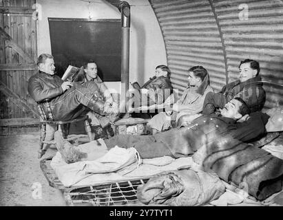 Photo Shows: Leading Aircraftsmen waiting in the rest hut of the RAF station for instruction 22 December 1940 Stock Photo