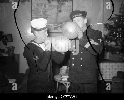 XMAS PARTY FOR FORCES OVERSEAS A Christmas party for the Forces overseas, far from their native lands was given at the Empire Rendezvous in Northumberland Avenue.  Members of the Forces from all over the Empire and from the countries of our Allies attended and participated in the general revelry.  22 December 1940  Photo Shows: An Australian seaman (left) tests his lungs against those of a Dutch naval airman in a balloon blowing contest. Stock Photo