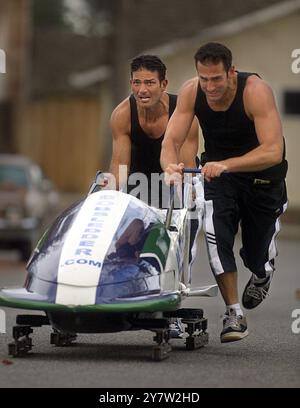 San Jose, Calif.--Bobsled athletes Yorgo Alexandrou, 29, and Dan Janjigian, 29, practice on a San Jose street. The men, who will be competing in the 2002 Winter Olympic Games in Salt Lake City, will represent Armenia in the bobsled event. Janjigian, who owns a Web site design company and is an Armenian by descent, became hooked on bobsledding while in Calgary, Canada, and later decided to compete for Armenia in the Salt Lake City Olympics. Janjigian and Alexandrou live 600 miles from the nearest bobsled run, so they practice on the street in front of Janjigian's home in San Jose, Calif. Alexan Stock Photo