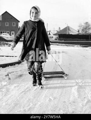 Wilmington, Kent, England was as good a place to go as anywhere on Sunday after the heavy snowfall, and here is Susan Jessop, of Brackendene Road, showing how.12 January 1960 Stock Photo