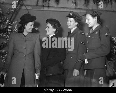 THE SERVICE SEE LATEST SPRING FASHIONS Members of the Services were specially invited to e pre-view of the latest Spring fashions at a London store.  On demobilisation women will receive 180 clothing coupons to refit them for civil life, and it was though that a display of forthcoming fashions might prove of assistance. Photo Shows: Girls of the Auxiliary Territorial Service, Womens Auxiliary Air Force and Womens Royal Naval Service get a close up of one of the latest Spring outfits. 5 March 1945 Stock Photo