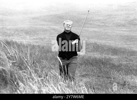 Carnoustie , Scotland :  Jack Nicklaus of the USA watches his shot on the second green after playing  his first round play in the British Open Golf Championship .  A the end of the round , Nicklaus , with many other players , stood at 76 - six strokes behind joint leaders, Michael Bonallack and Brian Barnes .11 July 1968 Stock Photo