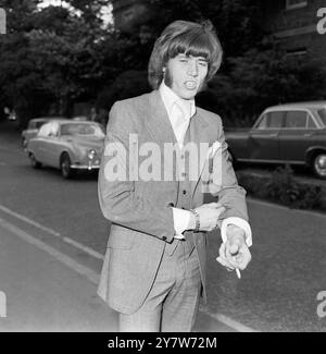 Bee Gees lead singer Barry Gibb, wearing a Recency style grey suit, shows off the £3000 diamond and ruby studded watch that got him into trouble with the Customs men and land him in court at Uxbridge near London this morning.Gibb, aged 23, is seen after his appearance in court where he was fined a total of £2000 on two Customs summonses relating to the wrist watch. The £1000 a week pop star pleaded guilty to attempting to evade customs duty and making a false declaration by saying that the watch had been bought in London. He was fined £1500 on the first summons and £500 on the second. 19 June Stock Photo