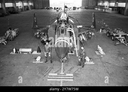 A Phantom jet, displaying its full striking power, on display, at the RAF Coningsby, Lincs, today. In the foreground standing either side of the plane, Left: Flight Lt John Hough from Aldershot, and Flight Lt Dave De Garis, from Guernsey. The Phantom will form part of the first RAF Phantom Squadron, to be formed in May this year. It will be No 6 Squadron, RAF Air Support Command, equipped with the Phantom FGR Mk 2. The RAF has ordered over 100 Phantoms.14 Janaury 1969 Stock Photo