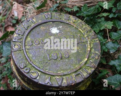 Cast Iron Boundary Marker on the footpath between Dawlish and Dawlish Warren in Devon.The foot path is inland above the main ralway line as it follows Stock Photo