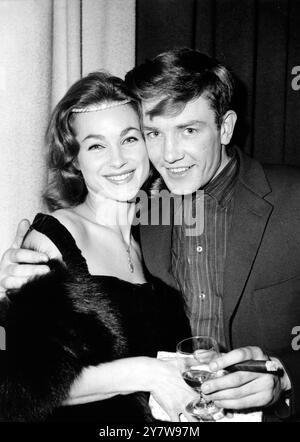 All dressed up for tonight's party in a London pub is up and coming actress Shirley Ann Field with casually dressed Albert Finney who to prove he's arrived on the theatrical and film scene smokes a thick cigar. Both artists were in the Leicester Square locale for the launching of thie new film - the screen adaptation of novelist Alan Sillitoe's phenomenal best seller, ' Saturday Night and Sunday Morning '. Alas for Albert he could not stay at the party long - he had to go off to appear in his current play ' Billy Liar ' at the Cambridge Theatre.26 October 1960 Stock Photo