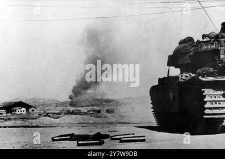 Parked on the bank of the Han River , a British Churchill tank is lobbing shells across the river into communist positions in Seoul . Spent shell cases are on the ground . United Nations patrols have repeatedly probed into the former capital of South Korea , but have been unable to hold positions there against communist counter attacks .18 February 1951 Stock Photo