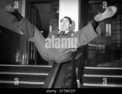 Unorthodox entry to British show business by American comedian Danny Thomas , seen doing a fast moving act on a stair rail at the Prince of Wales Theatre , London , England today . Thomas has just arrived in London to appear at the Palladium when it reverts to variety next Monday 27 March 1950 . Now ranked by his admirers as an entertainer as gifted as Danny Kaye , Al Jolson and Maurice Chevalier , Danny Thomas ( his real name is Amos Jahoob ) was born in Toledo , USA , one of 10 children of a Syrian candymaker . He is estimated to have been making as much as £2000 a week in American cabaret . Stock Photo