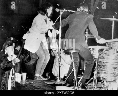 A fan gets on stage to grab the arm of Ringo Starr during a Beatles concert in Cleveland , Ohio , USA 16th August 1966 Stock Photo