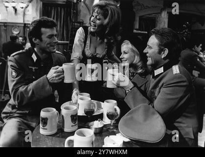 Clint Eastwood , Ingrid Bitt , Mary Ure and Richard Burton enjoy mugs of German beer whilst filming MGM's , ' Where Eagles Dare ' 1968 Stock Photo