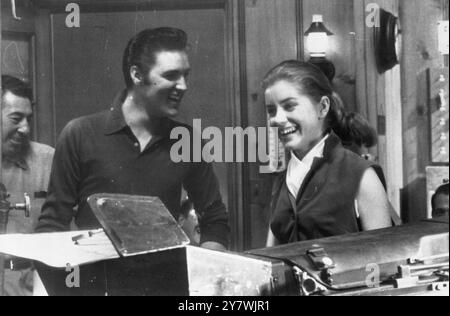 Elvis Presley plays the part of a small town boy who suddenly becomes a singing sensation in his new picture Loving You seen here with him is newcomer Dolores Hart. Here Presley pre records ten new songs which are to be introduced in the film. 7th February 1957 Stock Photo